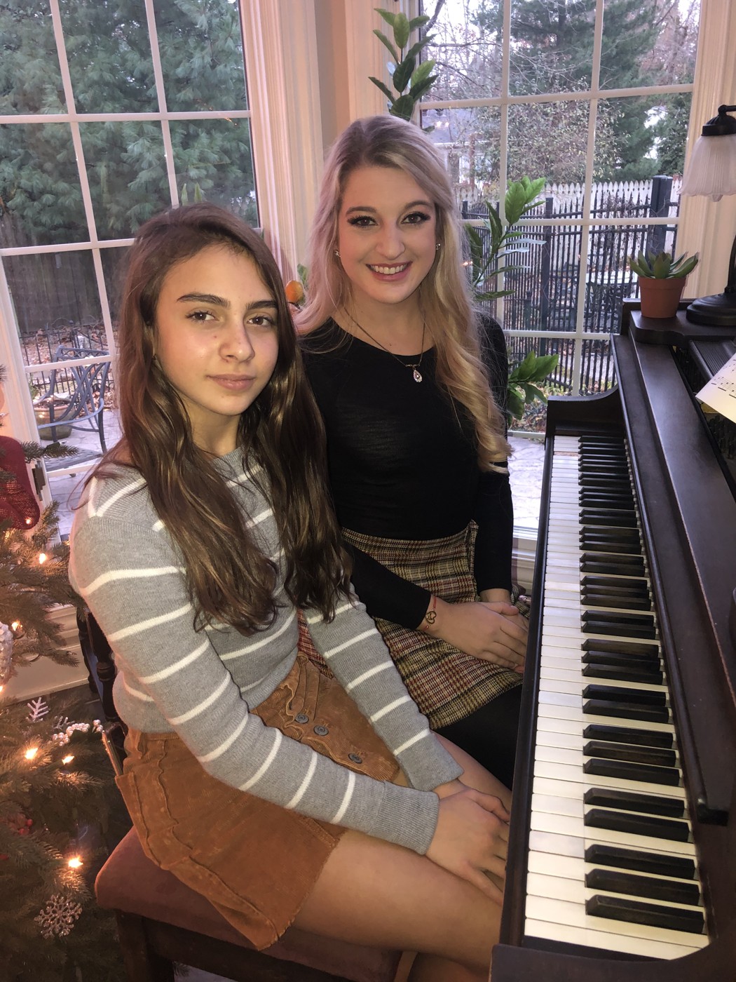 Madison with a student at the piano