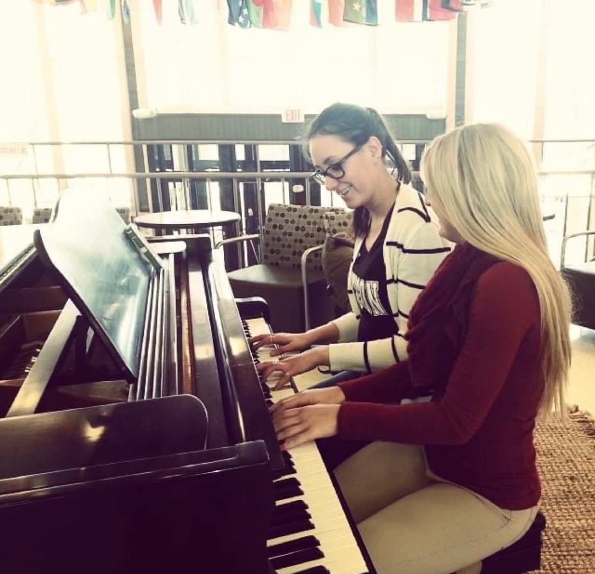Madison teaching a student at the piano